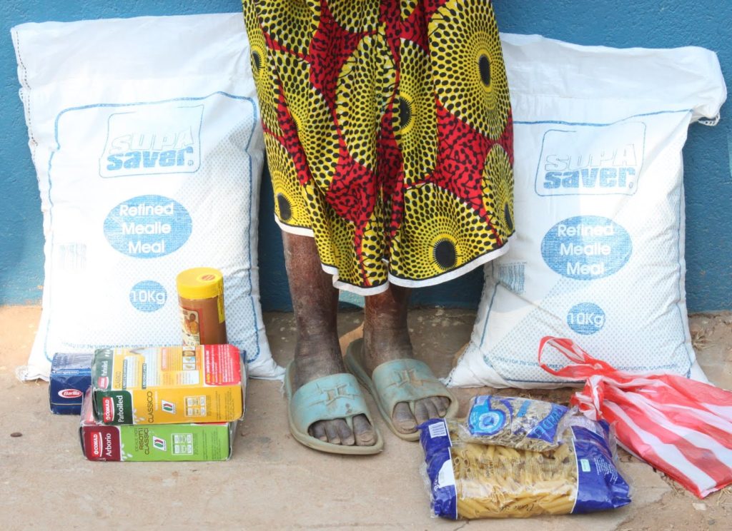 The contents of a food hamper that St. Albert's Mission Hospital has provided an 80-year old woman. Her feet and legs show signs of pellagra, a form of malnourishment.