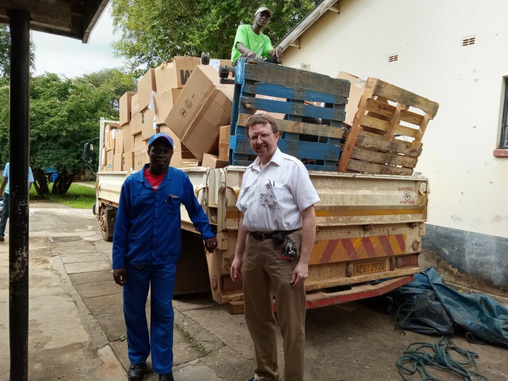 Photo of Dr. Paul Thistle and staff with truckload of boxed medical supplies included in the container of supplies sent by BHA to St. Albert's Mission Hospital.